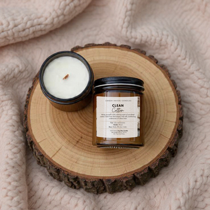 Candle and jar on a wooden coaster with a soft blanket background