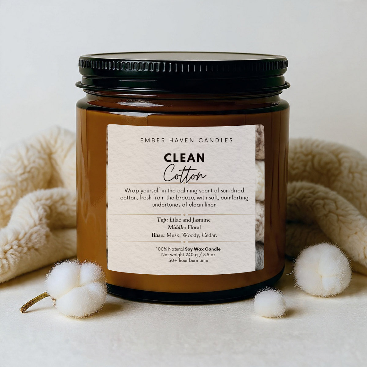 Candle jar labeled 'Clean Cotton' by Ember Haven Candles on a neutral background.
